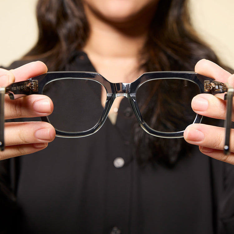 Model holding clean glasses